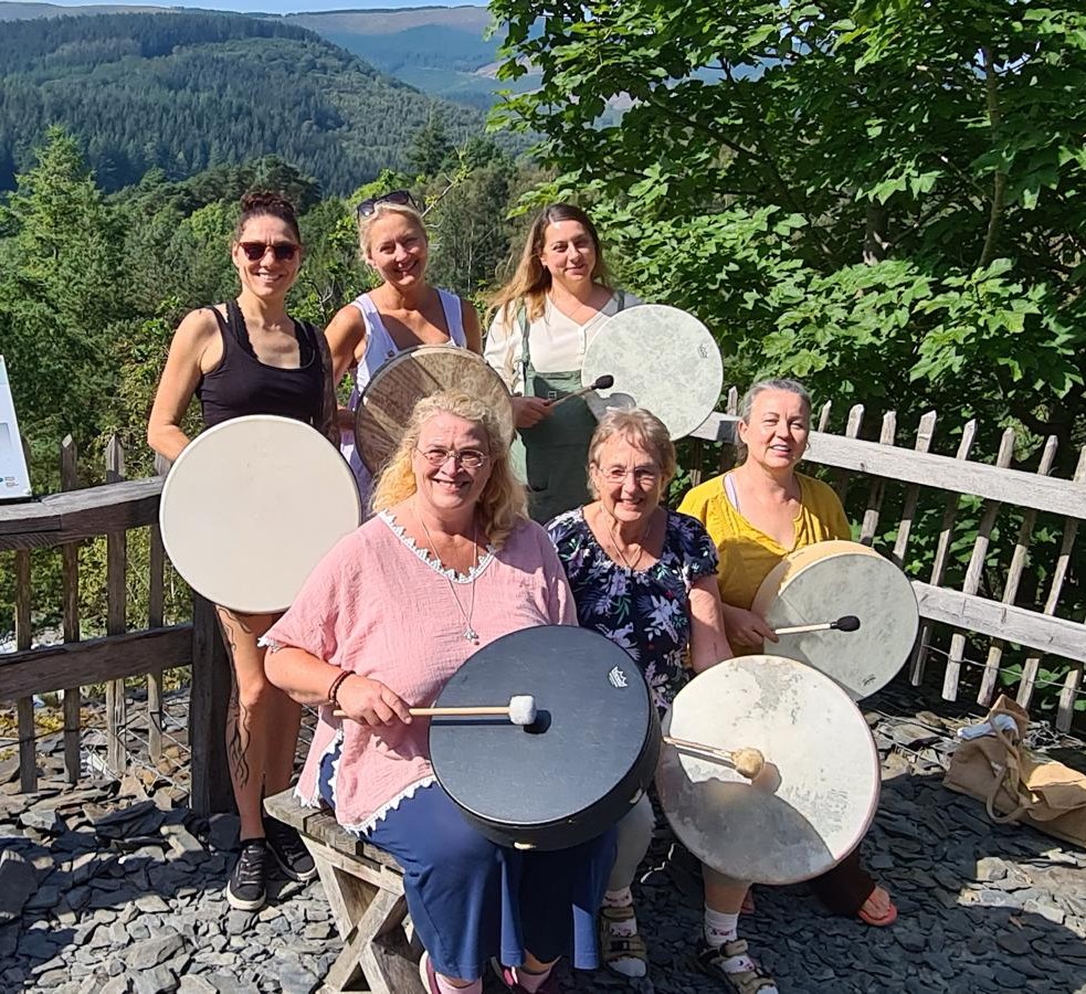 Maggie with a drumming group in nature